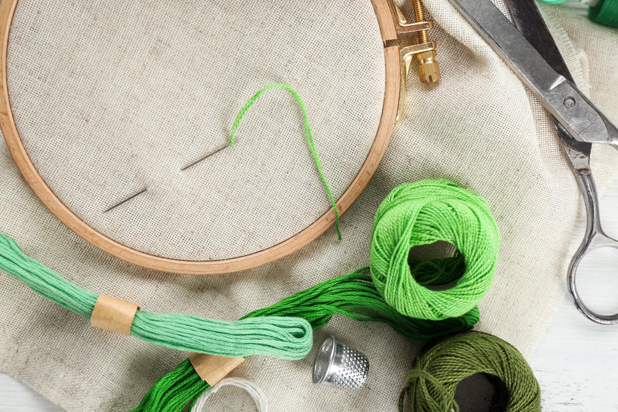 Open studio table with embroidery hoops and threads